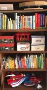 Tall bookshelf with children's toys