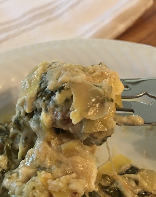 Spinach-artichoke casserole on fork