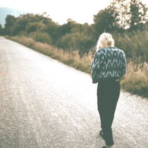 Woman walking on road grass