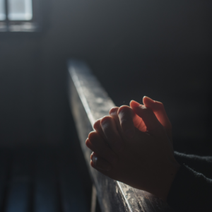 Praying hands in church