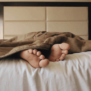 Cozy bedding feet under blanket