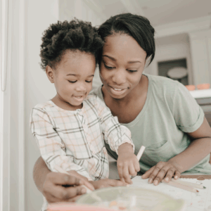Mom with child writing